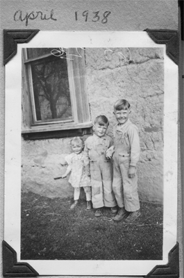 Lillie, Don and Jim alongside big adobe house